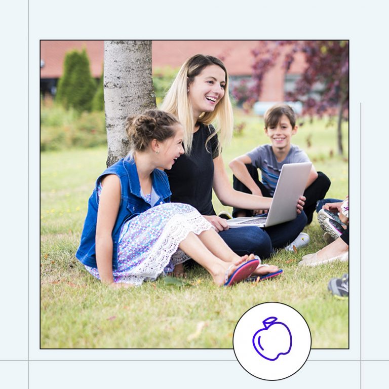 school teacher sitting outside holding a classroom session outdoors