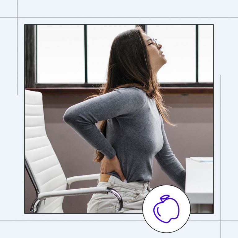 woman with lower back pain sitting in chair