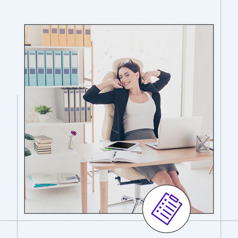 woman stretching while sitting at a workstation