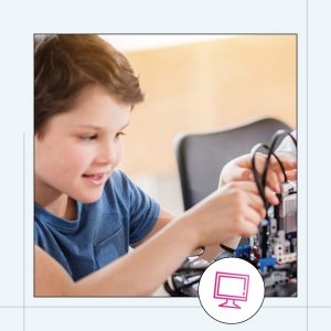 a young boy enjoying experimenting with a robotic machine