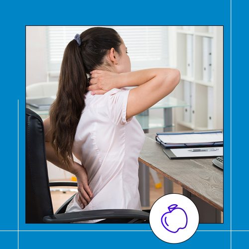 woman at desk stretching back