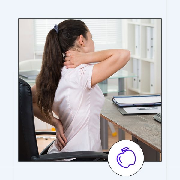 woman at desk stretching back