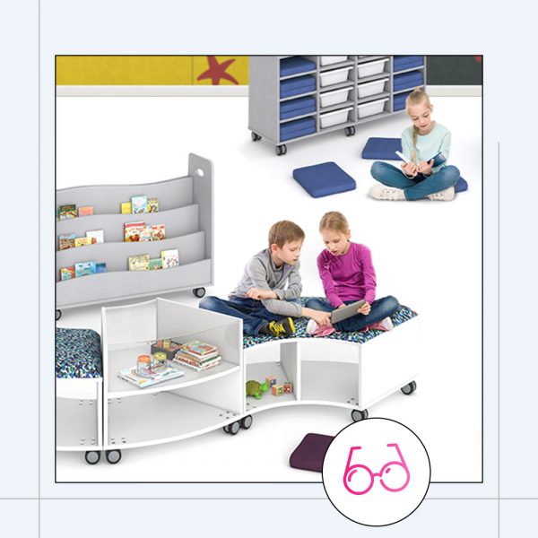 classroom setting with multiple children including mobile bookshelves and a curved lounge setting