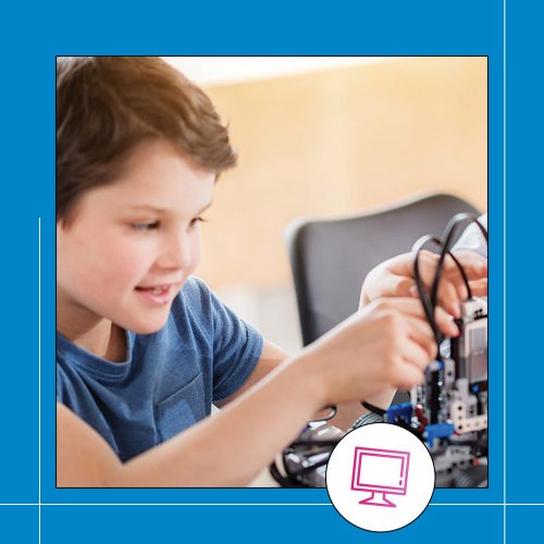 a young boy enjoying experimenting with a robotic machine