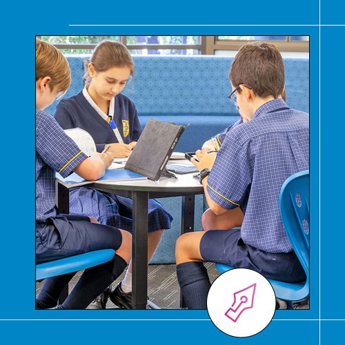 high school students sitting at a desk together studying