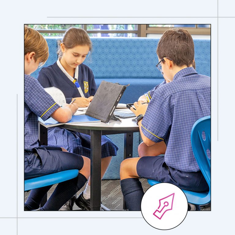 high school students sitting at a desk together studying