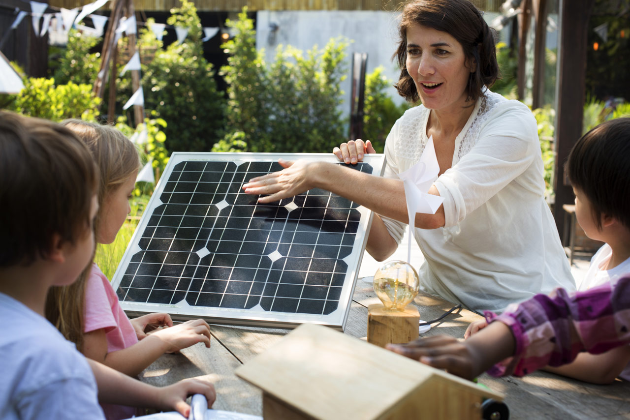 teacher showing solar power to kids